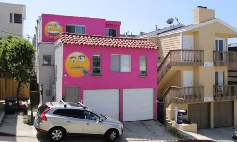 Bright pink house decorated with emojis is result of neighbor’s quarrel