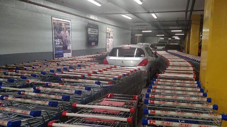 Man parks wrongly after which his car is enclosed by shopping trolleys
