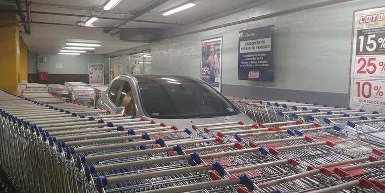 Man parks wrongly after which his car is enclosed by shopping trolleys 