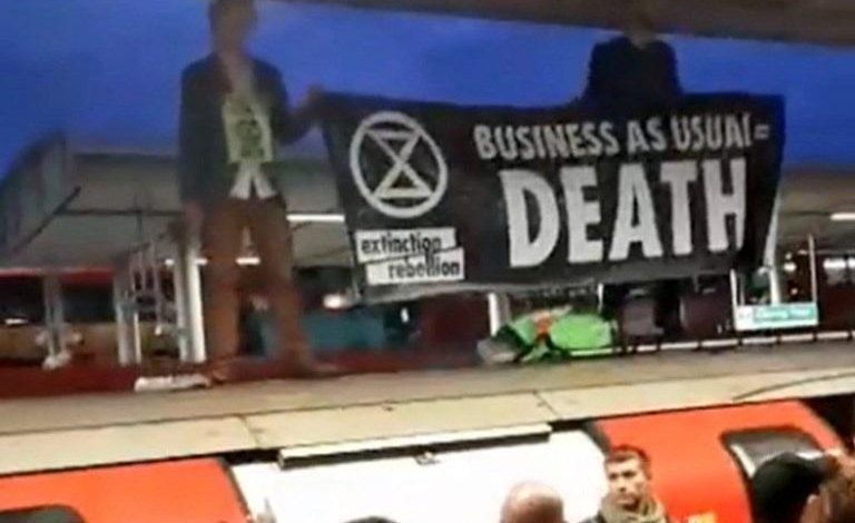 Furious commuters drag climate protesters off their train