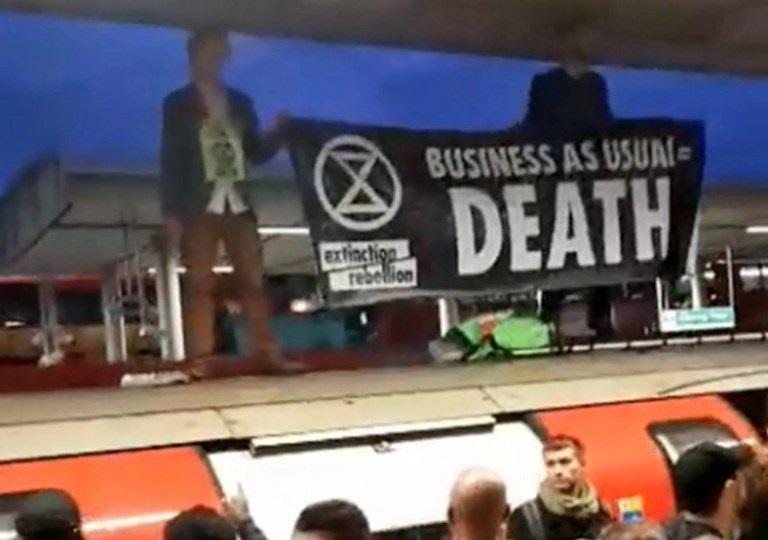 Furious commuters drag climate protesters off their train