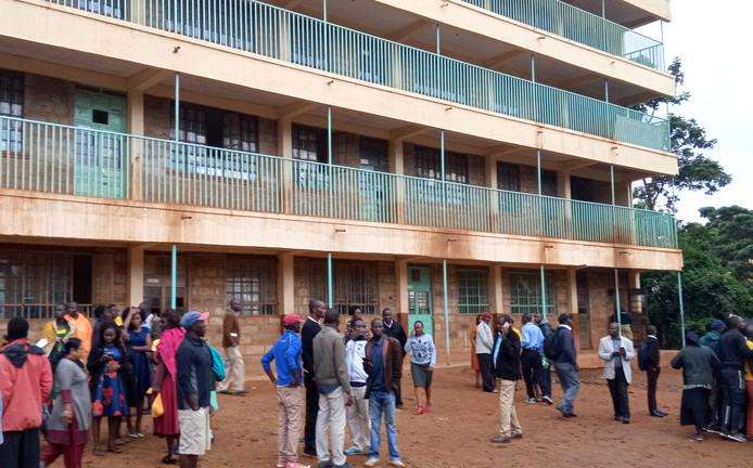 Parents and teachers gather at the school in Kakamega, Kenya, where tumult at least thirteen children became fatal