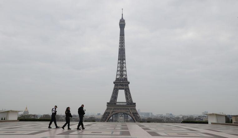 Only three officers populate the Esplanade du Trocadero, the square in front of the Eiffel Tower in Paris.
