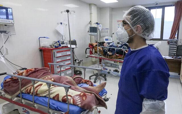 A nurse cares for patients in a ward dedicated to people infected with the coronavirus, at Hospital in Qom, Iran, Feb. 26, 2020.