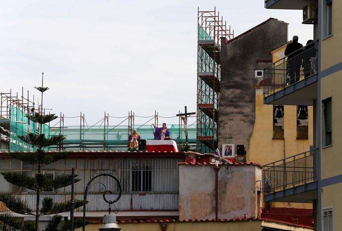  From their balcony, Italians in Naples attend an open-air mass, served by two priests from the Santa Maria Della Salute parish. 