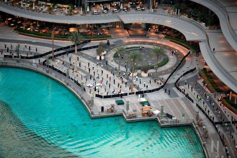 People keep their distance while watching the Dubai fountain show.

