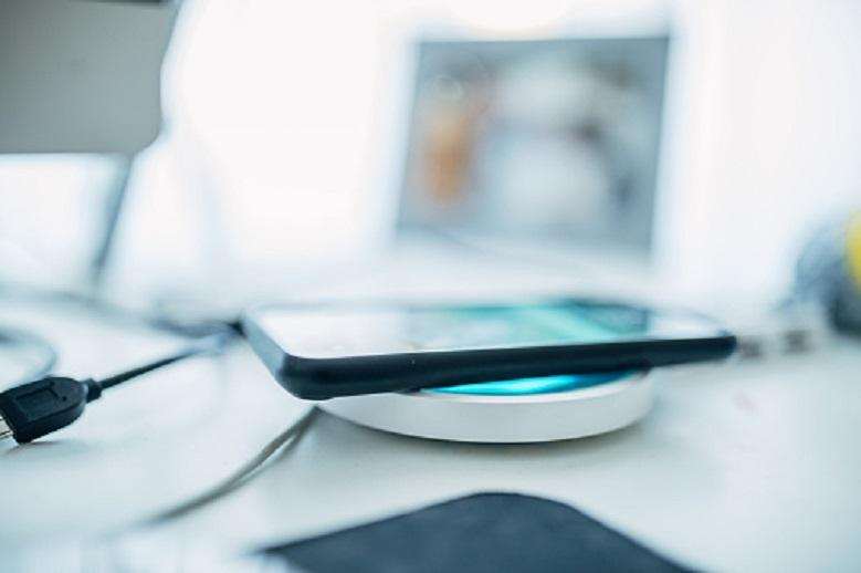 Smart phone on a modern wireless charger.