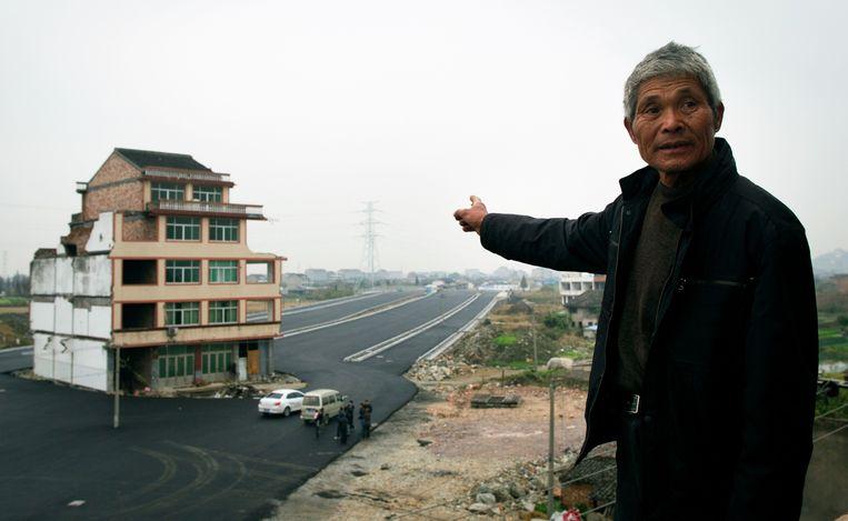 a main road has been built around a house in China.