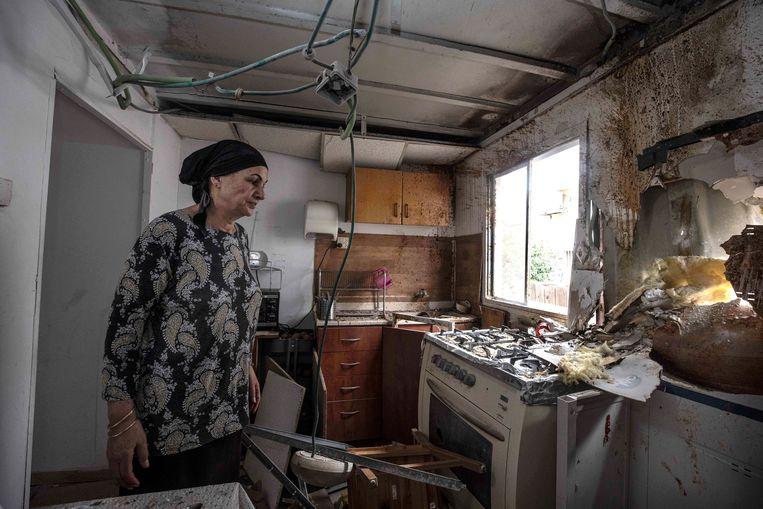 A resident of Sderot measures the damage to her house after a missile attack from the Gaza Strip.