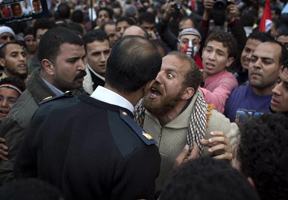 In Egypt, around 1,000 people died due to mass protests that were accompanied by clashes with the police. Pictured: A protester argues with a policeman in Tahrir Square in Cairo, February 13, 2011.