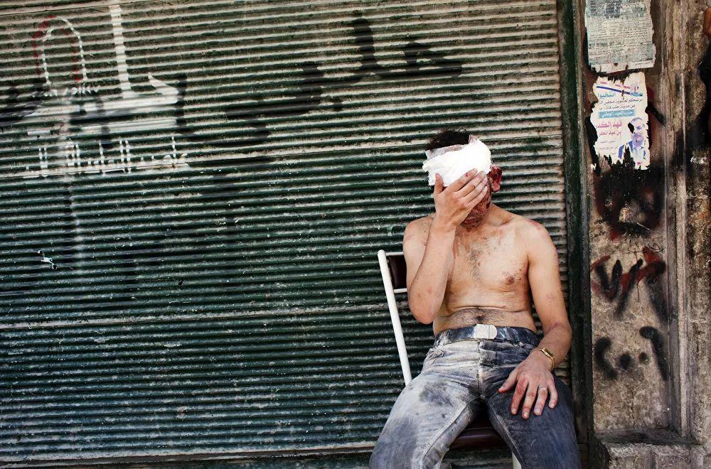 Man injured in a bombardment in front of a closed shop in Aleppo, September 4, 2012.