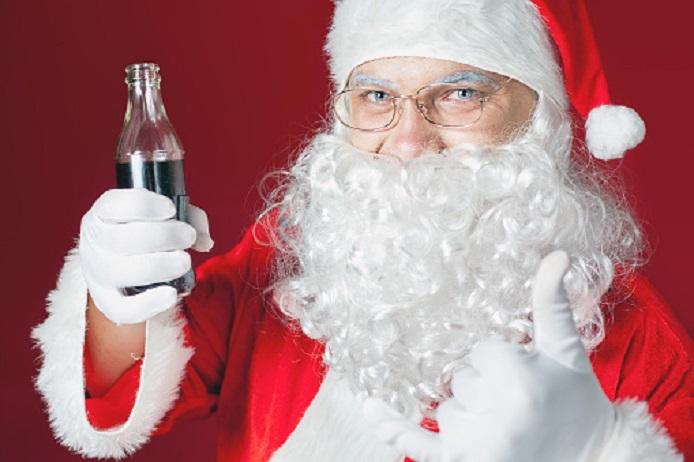 Funny Santa Claus holding Coca Cola fresh beverage at glass bottle