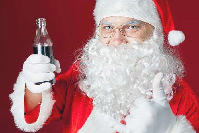 Funny Santa Claus holding Coca Cola fresh beverage at glass bottle