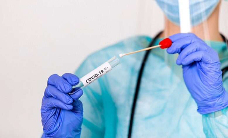 Lab technician holding swab collection kit,Coronavirus COVID-19 specimen collecting equipment,DNA nasal and oral swabbing for PCR polymerase chain reaction laboratory testing procedure and shipping