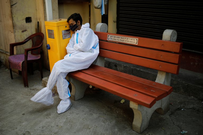 An exhausted worker, due to the days of care for patients with COVID-19 in New Delhi, India
