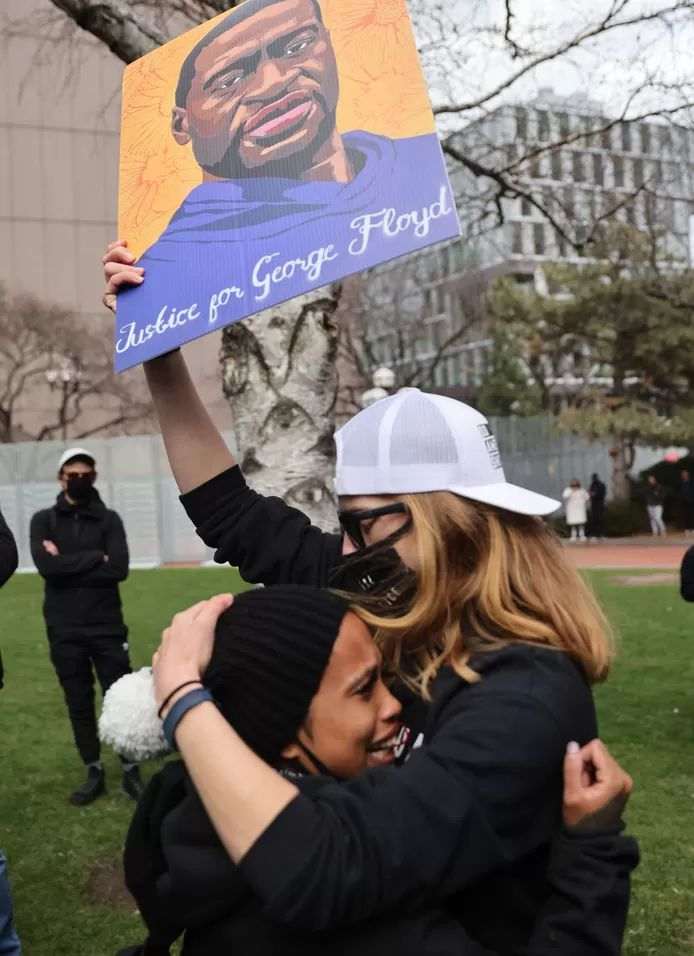 Women crying into each other's arms after the Minneapolis verdict