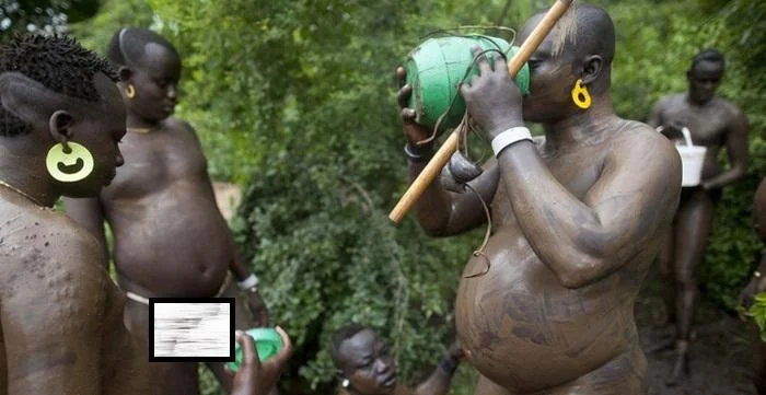 Bodi tribal men drinking blood with milk