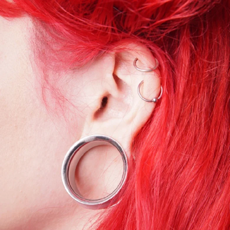 What are body modifications other than piercings and tattoos?