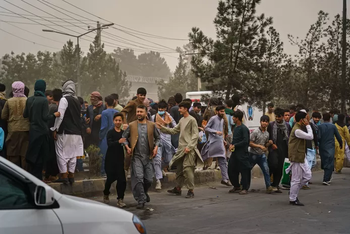 Taliban fighters attack crowds with firearms, whips, and sticks