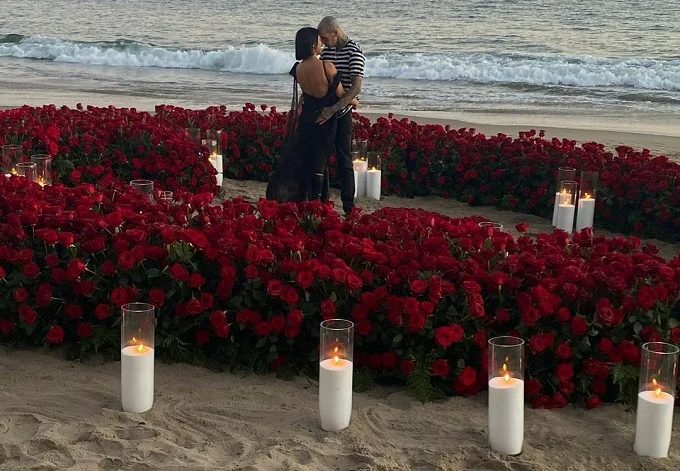 Hundreds of red flowers and candles circled Kourtney Kardashian as she engaged