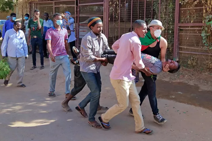 Sudanese protesters  try to get an injured man to safety. According to a pro-democracy medical union, soldiers targeted “the head, neck or torso” of the protesters.