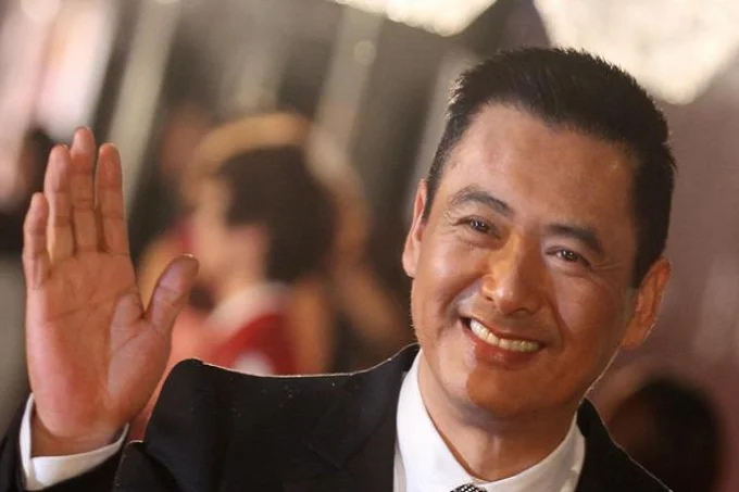 Why does Chinese actor Chow Yun-Fat distribute his money to the poor