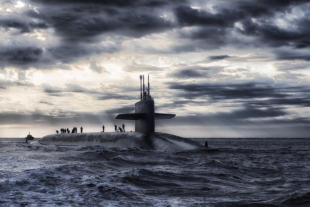 black is much better at camouflaging a submarine, especially given its low profile relative to the surface of the water