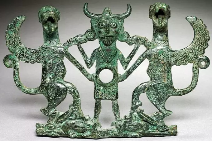 Another Luristan bronze figurine depicts two animals and a man in the center.