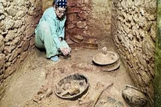 An archaeologist at the newly excavated tomb of Te Kaab Chaak, the first ruler of Caracol, surrounded by ceramic vessels and jade artifacts that reveal the complex burial rites of ancient Mayan royalt