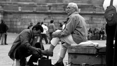 Cleaning shoes on the street in the early 20th century